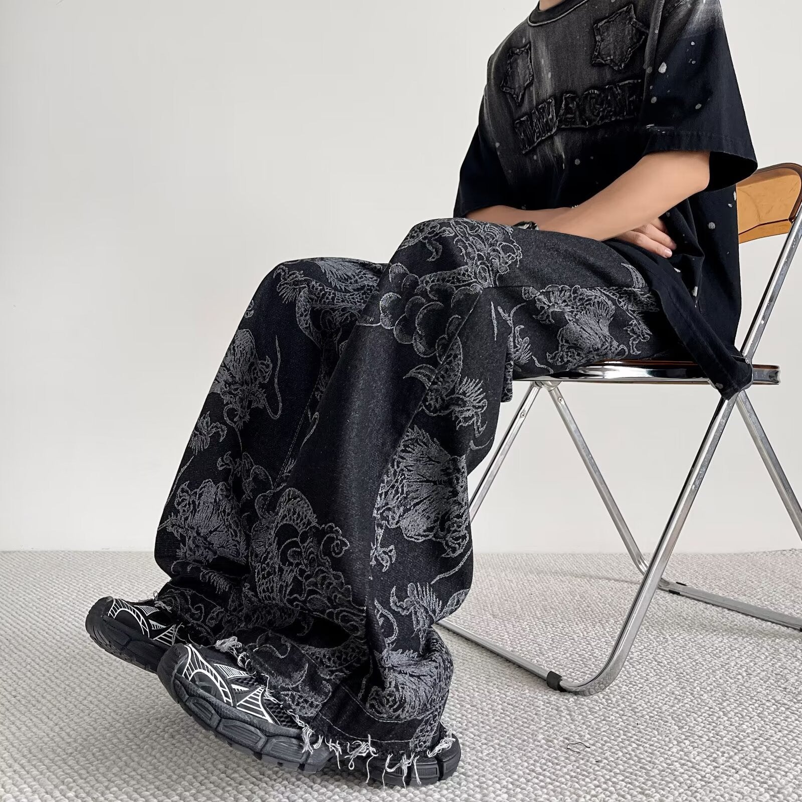 Side profile of Select Society Dragon Embroidered Black Jeans, emphasizing the sleek cut and unique design.